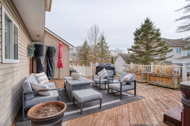 wooden deck with grilling area and outdoor lounge area