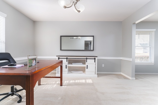 office area with baseboards, a chandelier, and carpet flooring