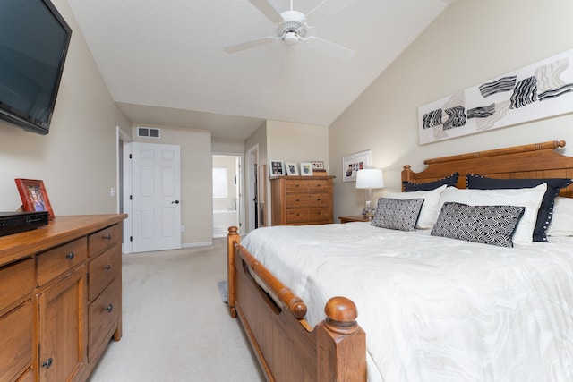 bedroom with ceiling fan, light carpet, visible vents, vaulted ceiling, and ensuite bath