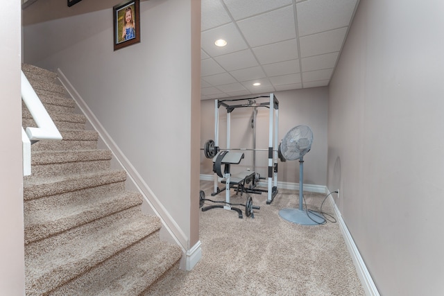 workout room featuring recessed lighting, carpet flooring, a paneled ceiling, and baseboards