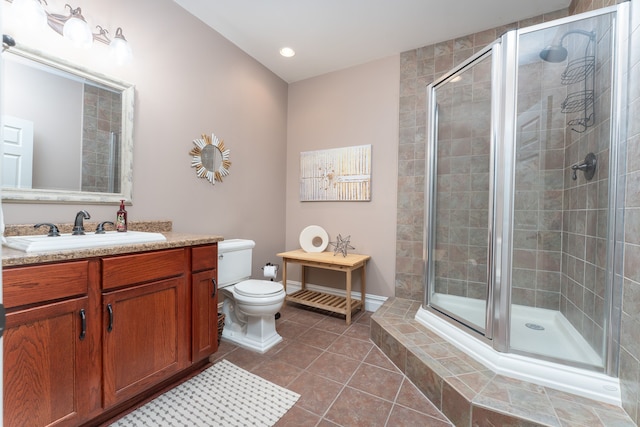 full bath featuring tile patterned flooring, a shower stall, toilet, and vanity