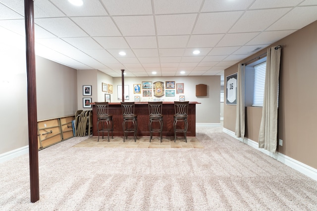 bar featuring baseboards, carpet flooring, and a dry bar