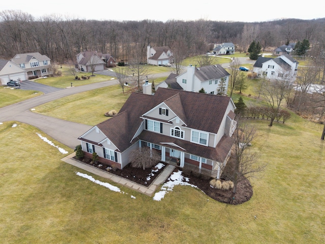 birds eye view of property featuring a residential view and a view of trees