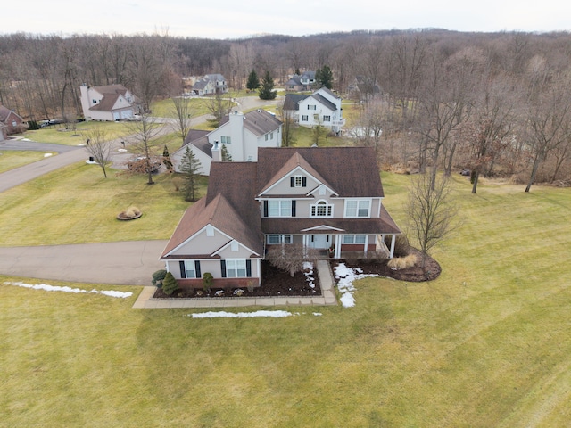 drone / aerial view featuring a forest view