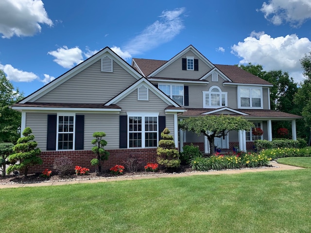 view of front of home with brick siding and a front lawn