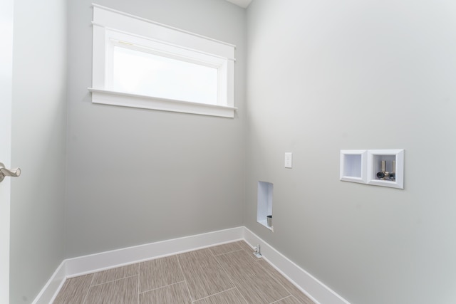 washroom featuring gas dryer hookup, laundry area, baseboards, and washer hookup