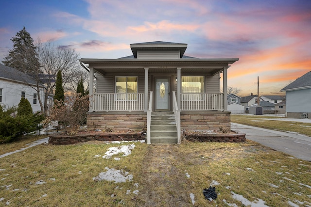 bungalow-style house featuring a porch and a front yard