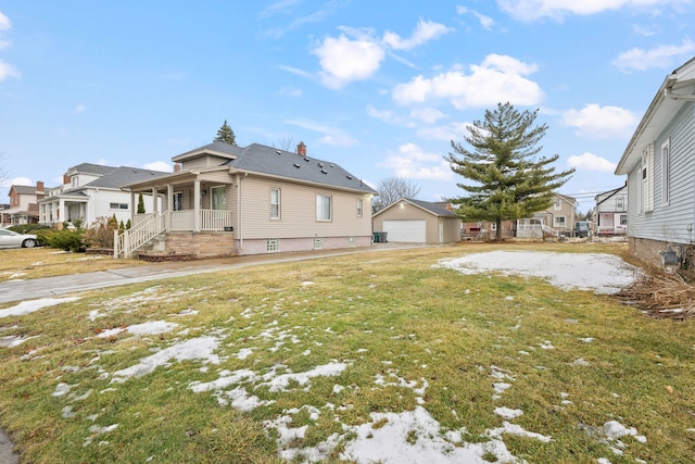 exterior space with a garage, an outbuilding, covered porch, and a residential view