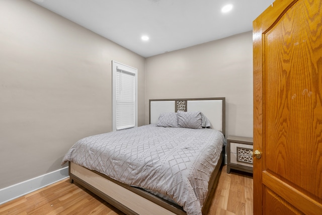 bedroom with recessed lighting, light wood-style flooring, and baseboards