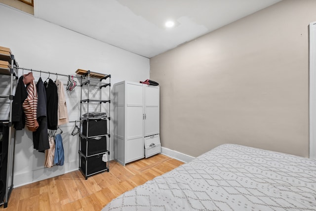 bedroom featuring light wood-style flooring and baseboards