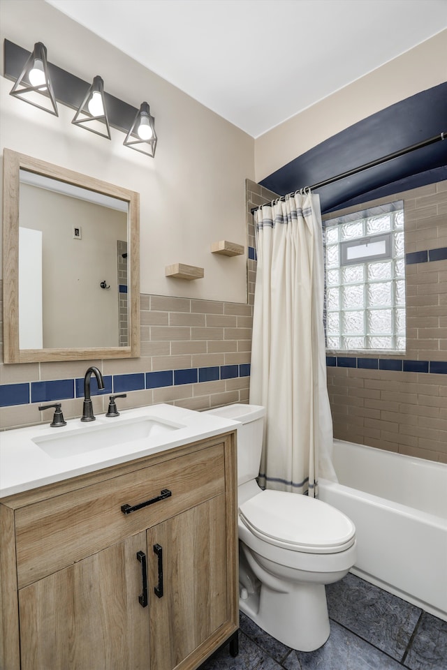 bathroom with shower / bath combo with shower curtain, toilet, tile walls, and vanity