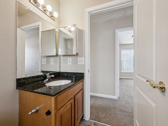 bathroom featuring vanity and baseboards