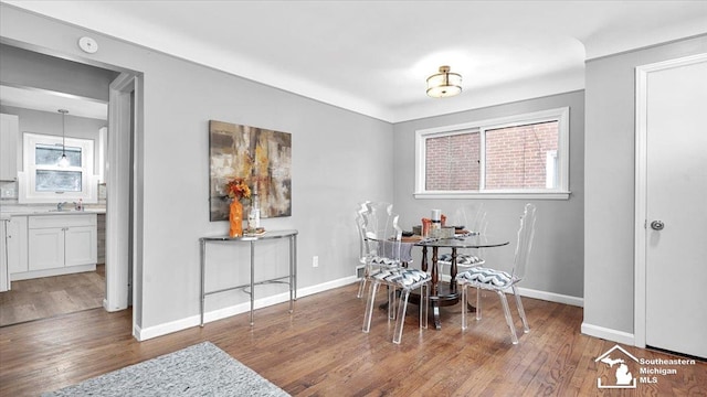 dining room with dark wood-type flooring and baseboards