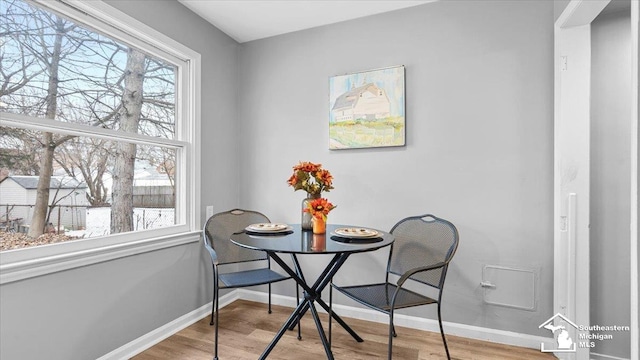 dining room featuring baseboards and light wood-style floors