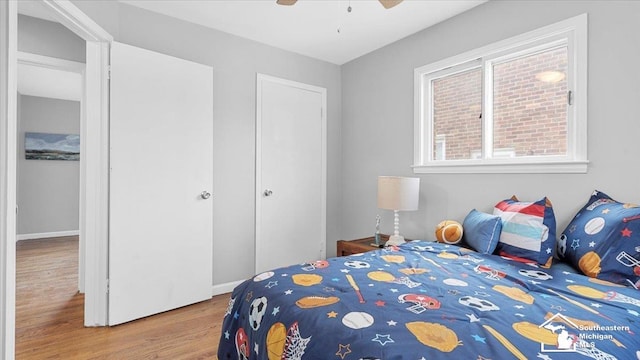 bedroom with ceiling fan and wood finished floors