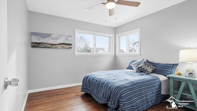 bedroom with dark wood-style flooring, ceiling fan, and baseboards