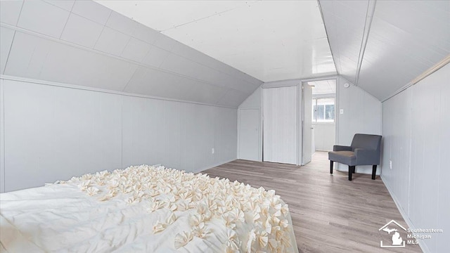 bedroom featuring lofted ceiling and wood finished floors