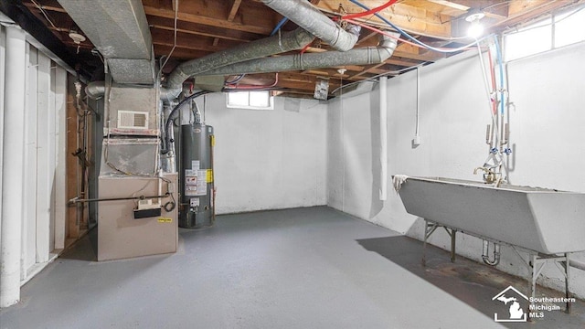 basement with a sink, visible vents, and gas water heater