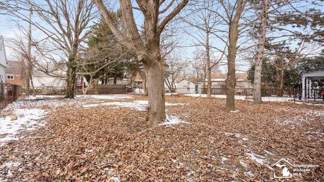 snowy yard with fence