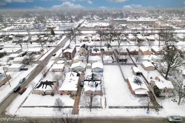 snowy aerial view featuring a residential view