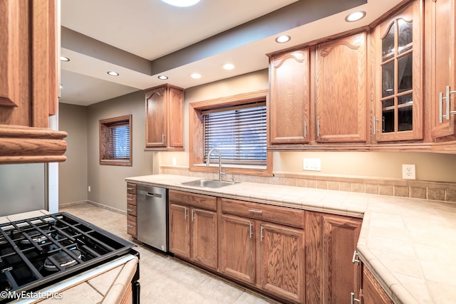 kitchen with range, dishwasher, glass insert cabinets, a sink, and recessed lighting