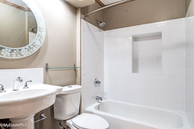 full bathroom featuring a sink, bathing tub / shower combination, and toilet