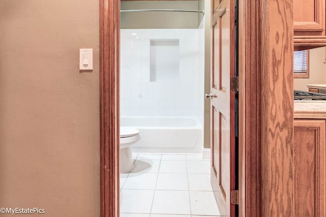 full bathroom with toilet and tile patterned flooring