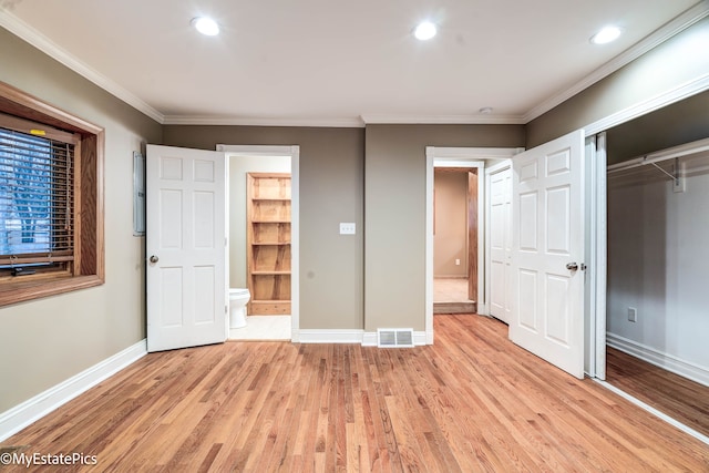 unfurnished bedroom featuring visible vents, ornamental molding, light wood-style flooring, and baseboards