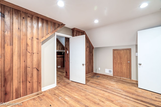 additional living space featuring baseboards, visible vents, wood finished floors, vaulted ceiling, and recessed lighting