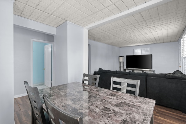 dining area with dark wood-style floors and baseboards