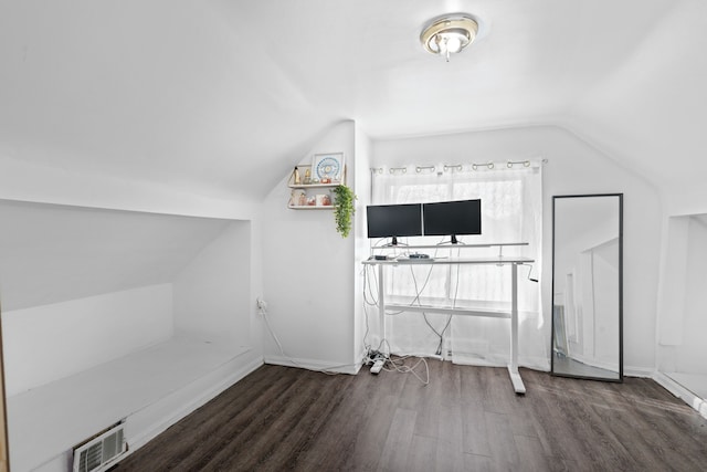 additional living space with lofted ceiling, visible vents, dark wood finished floors, and baseboards