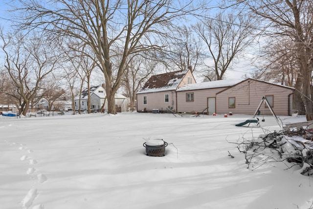 snowy yard with an outdoor fire pit