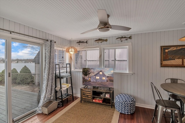 dining space featuring ceiling fan, baseboards, and wood finished floors