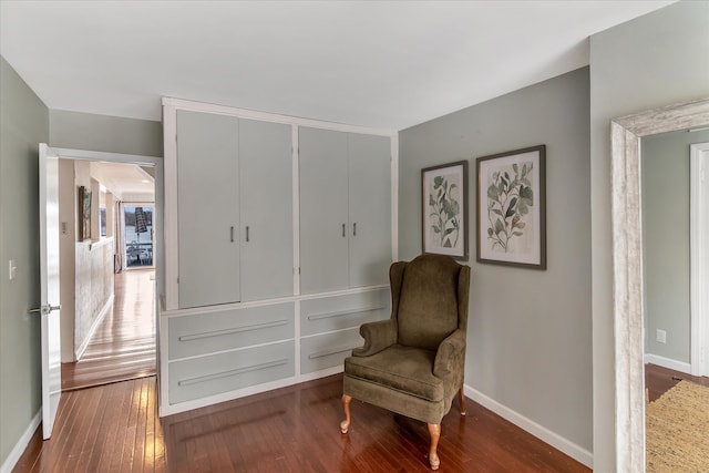 living area featuring hardwood / wood-style floors and baseboards