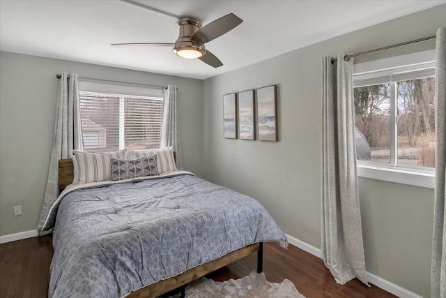 bedroom featuring ceiling fan, baseboards, and wood finished floors