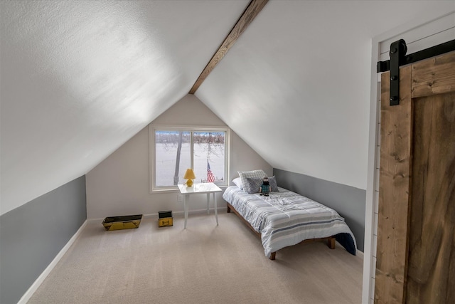 carpeted bedroom featuring baseboards, a barn door, and vaulted ceiling