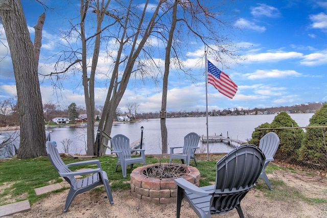 exterior space with an outdoor fire pit and a water view