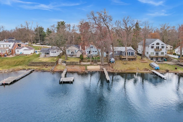 property view of water featuring a residential view, stairway, and a boat dock