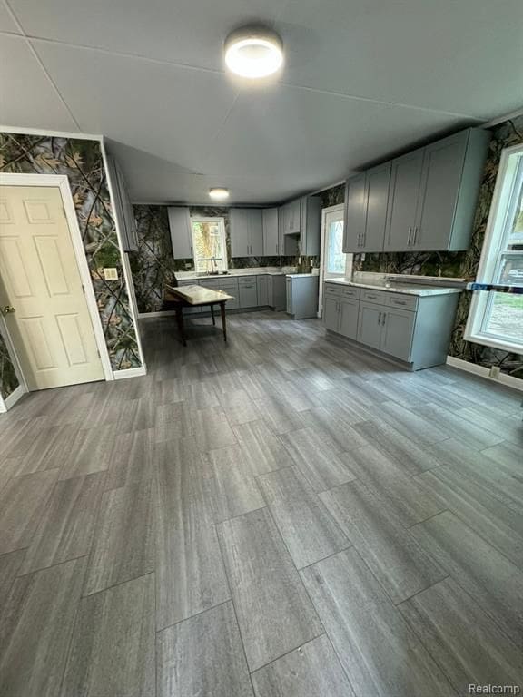 kitchen with light countertops, plenty of natural light, backsplash, and gray cabinetry