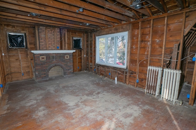 interior space with radiator heating unit and a fireplace