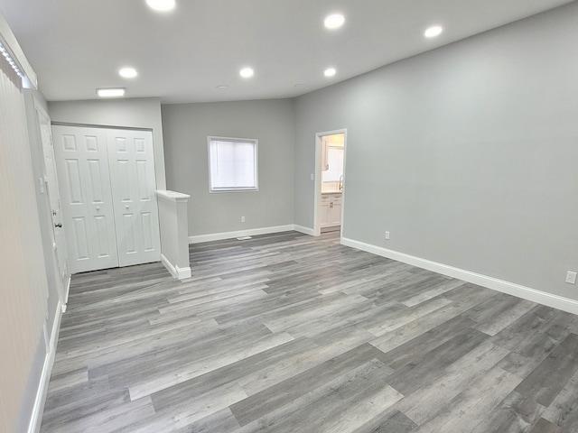 interior space with baseboards, light wood-style flooring, and recessed lighting