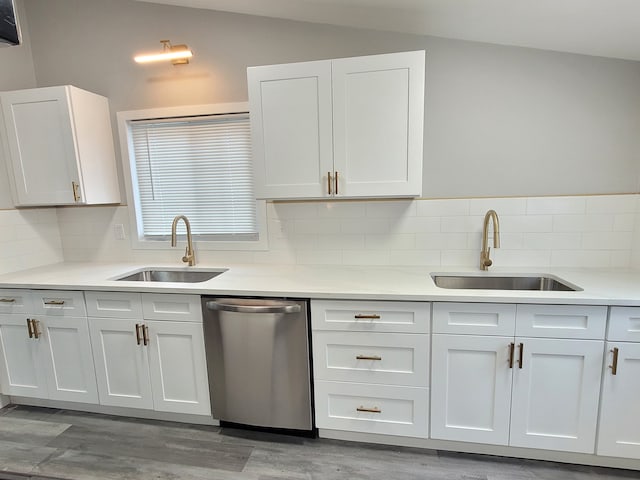 kitchen with light countertops, white cabinets, and dishwasher