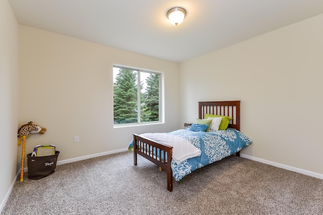 carpeted bedroom with baseboards