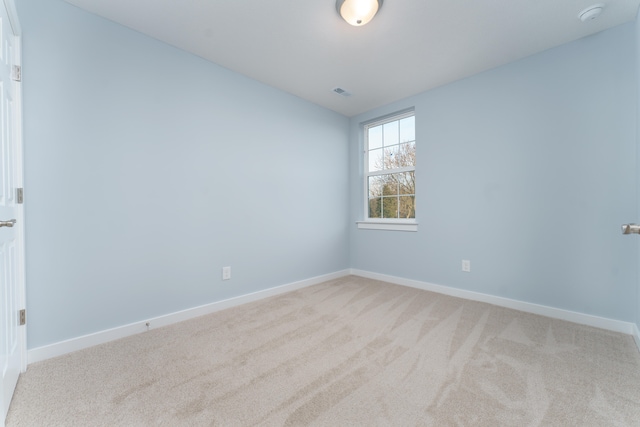5124 Huggins Rd, Michigan Center, MI 49254 - empty room featuring light carpet, visible vents, and baseboards
