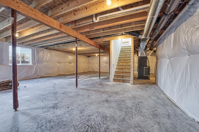 5124 Huggins Rd, Michigan Center, MI 49254 - below grade area featuring heating unit and stairway