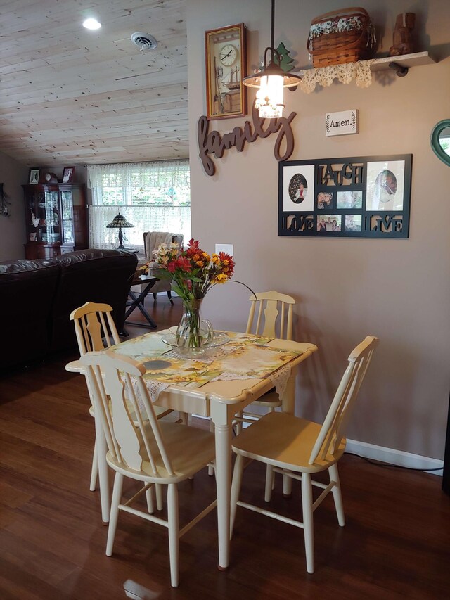 dining space with visible vents, wood ceiling, baseboards, and wood finished floors