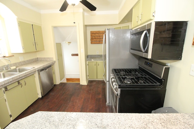 kitchen with a sink, crown molding, stainless steel appliances, and light countertops