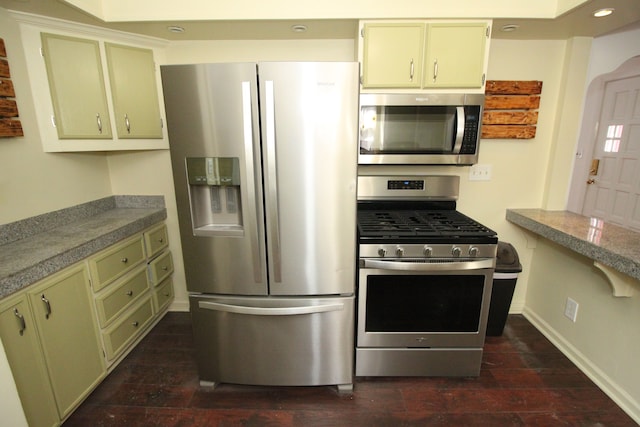 kitchen with recessed lighting, baseboards, green cabinets, appliances with stainless steel finishes, and dark wood-style floors