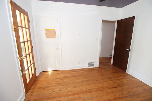 unfurnished room featuring french doors, visible vents, and light wood finished floors