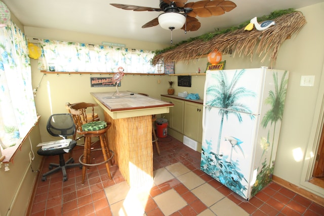 kitchen featuring tile countertops, light tile patterned floors, and a kitchen breakfast bar